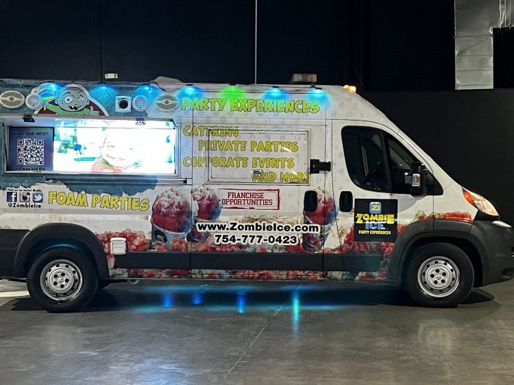 The Zombie Ice truck lit up at night during an event