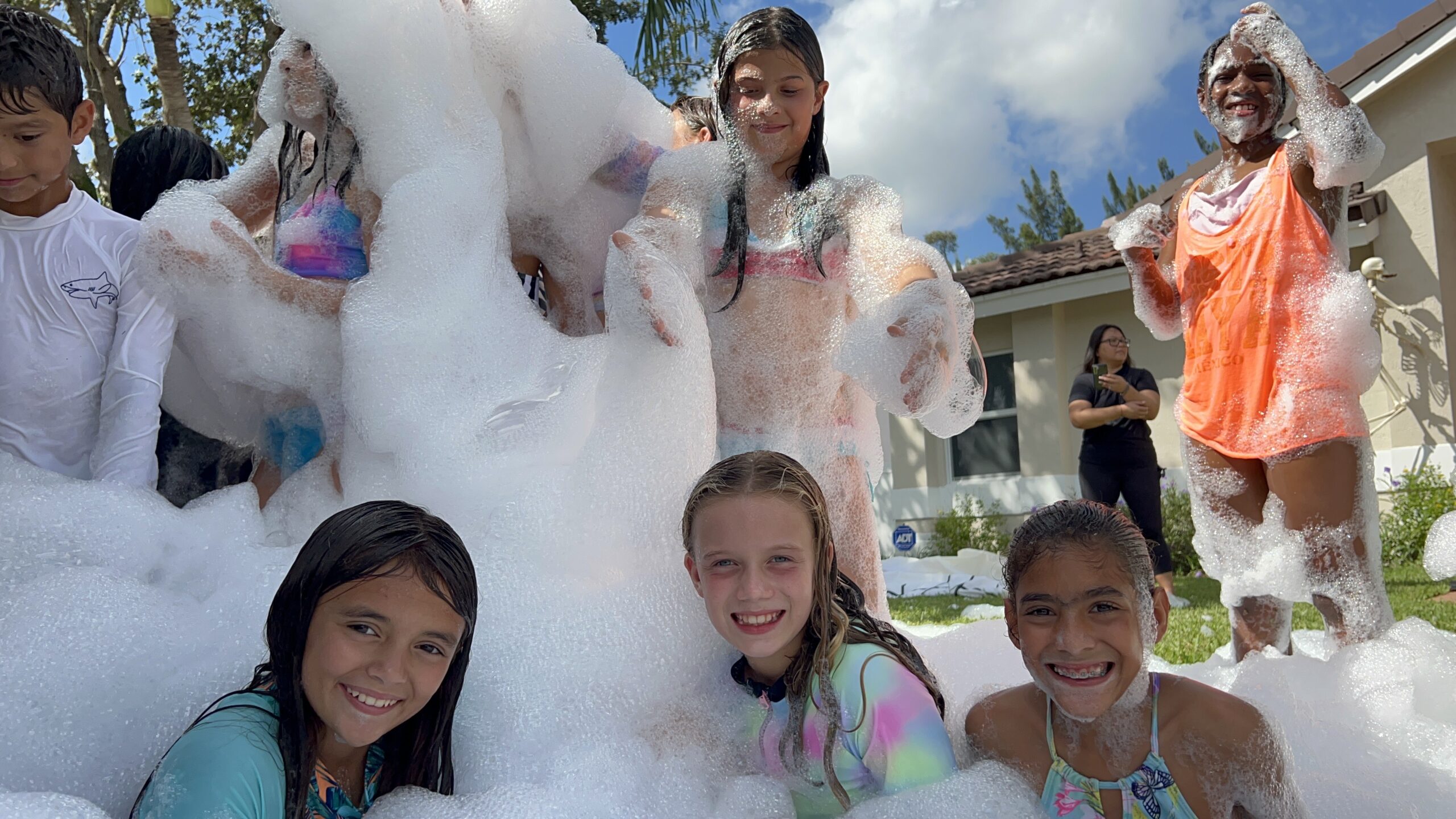 girls smillling playing in the foam party