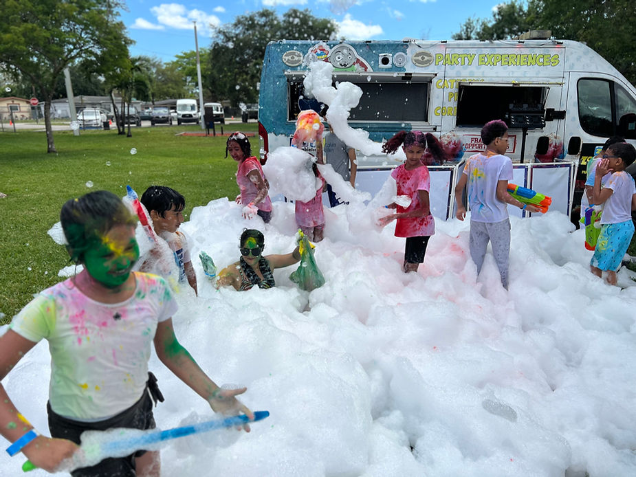 kids enjoying teh foam party with dye on their face and shirts