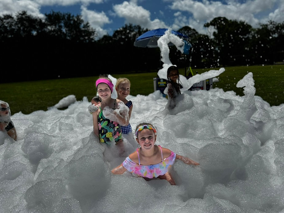 three girls enjoying and swimming in foam parties