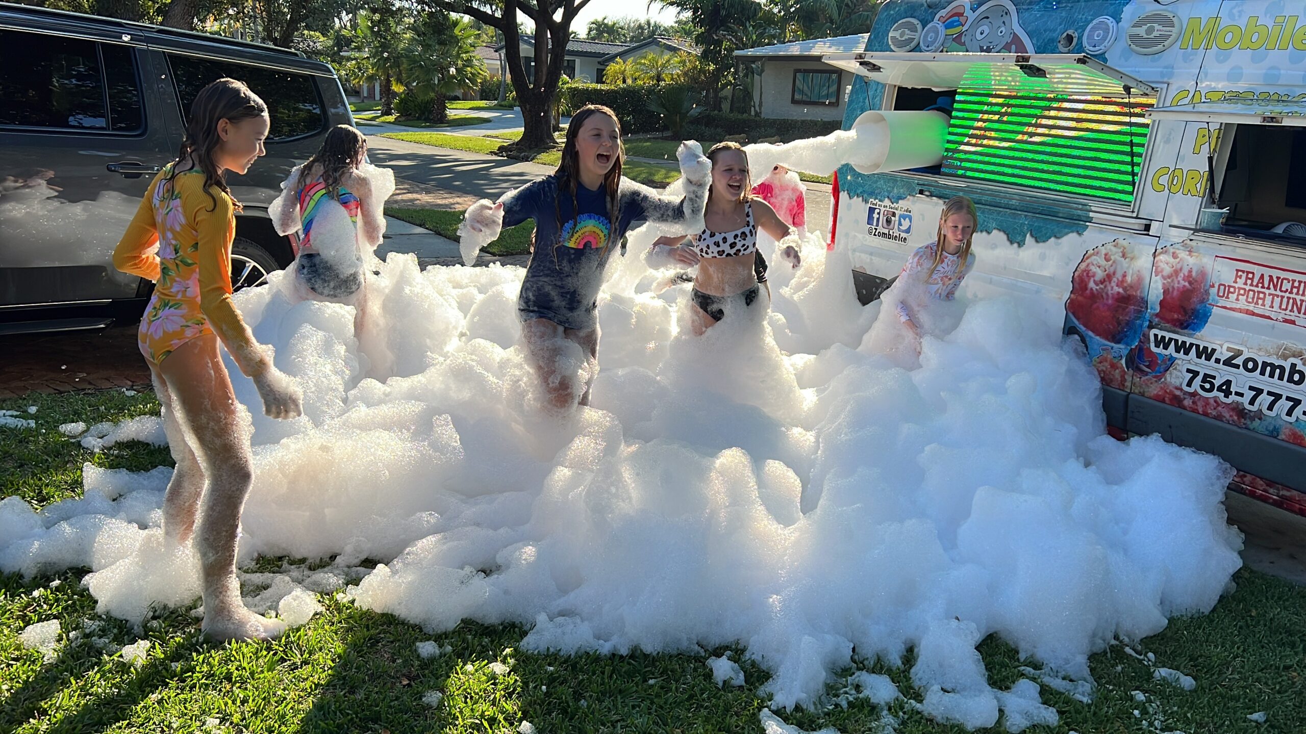 Teens playing in bubbles at a foam party