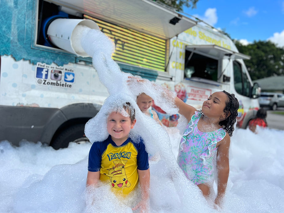 cute little boy enjoying on foam party
