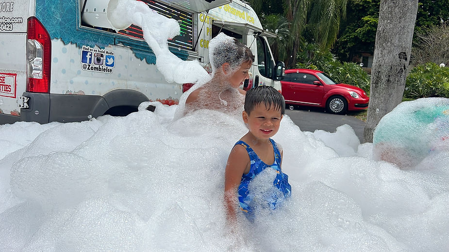 little boy in blue swimming in foam 