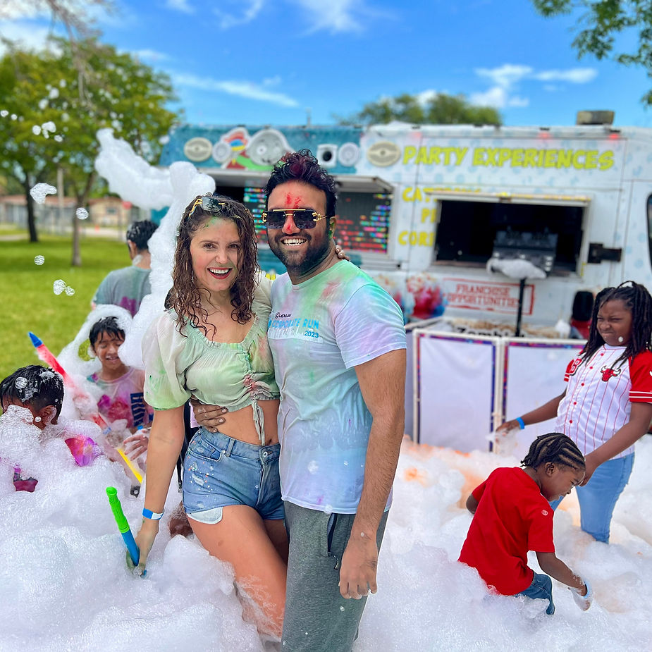 couple enjoying the foam party with paints in thier shirts