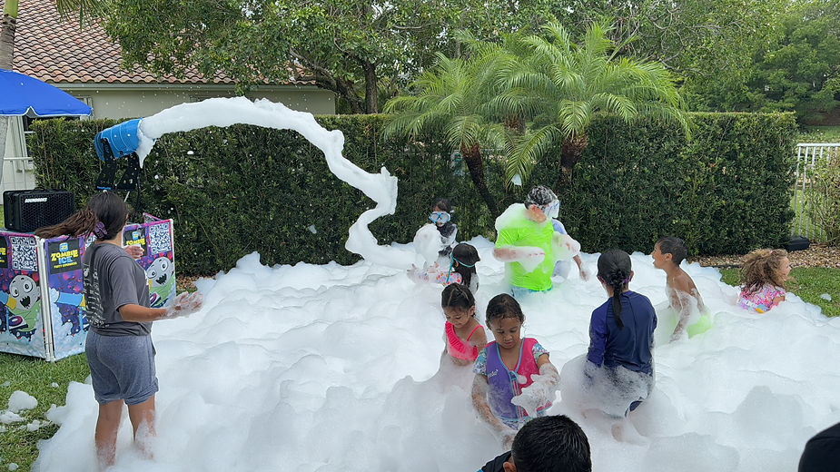 foam party machine rental with kids bathing on foam