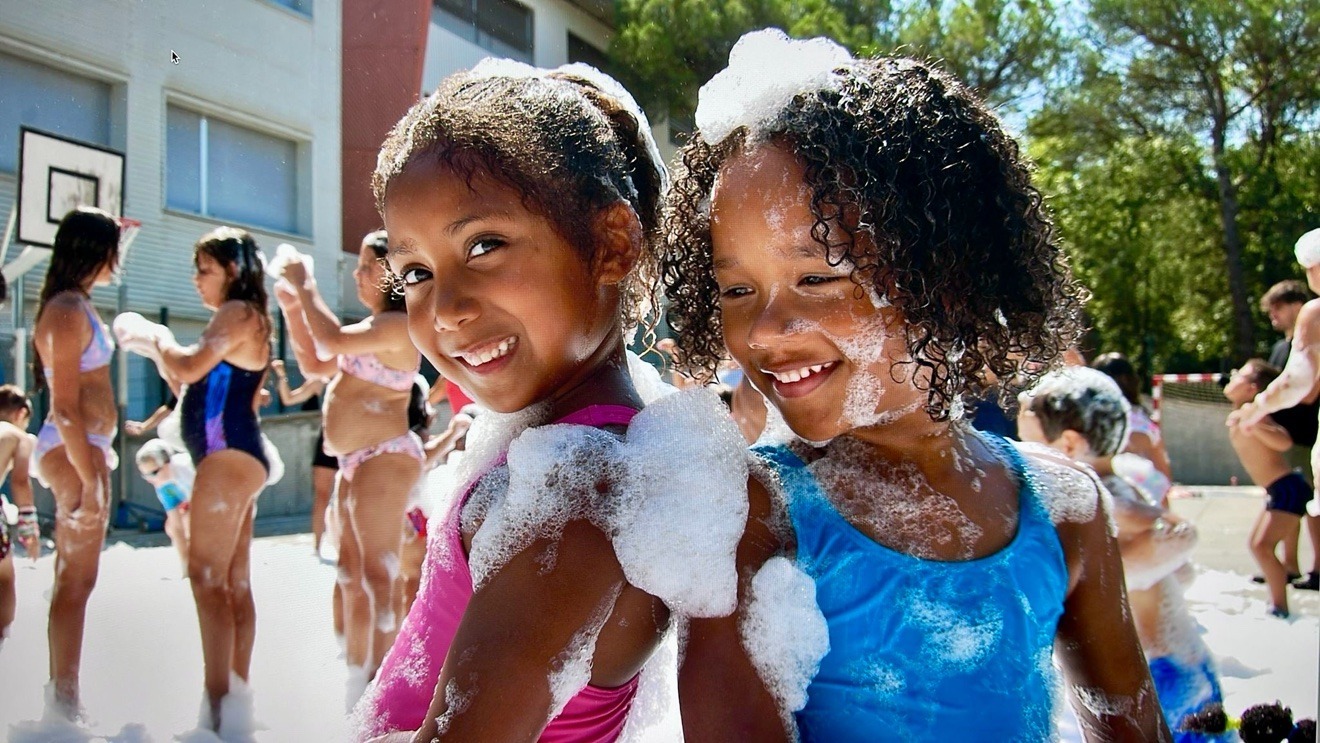 Two girls playing in foam at a Zombie Truck Foam Experience school party